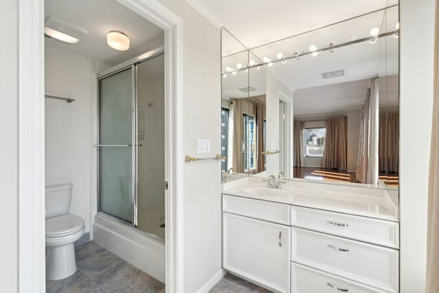 bathroom with tile patterned floors, vanity, toilet, and a shower with door