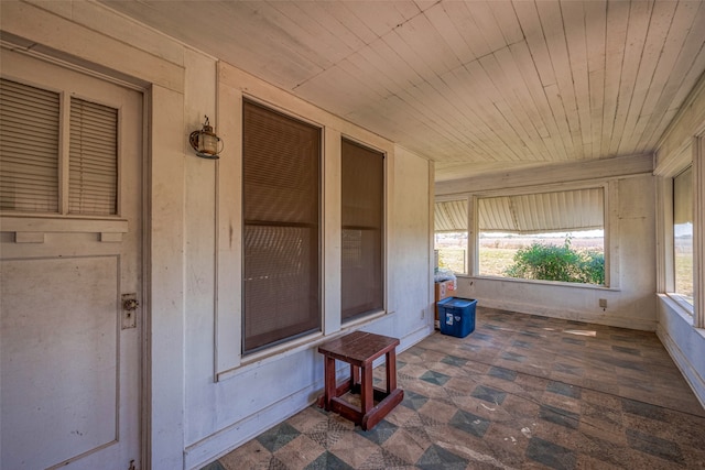 unfurnished sunroom featuring wooden ceiling