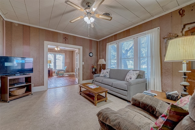 living room featuring light wood-type flooring, plenty of natural light, and wooden walls