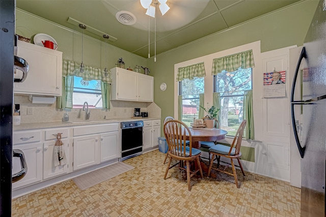 kitchen with white cabinets, decorative light fixtures, plenty of natural light, and black dishwasher