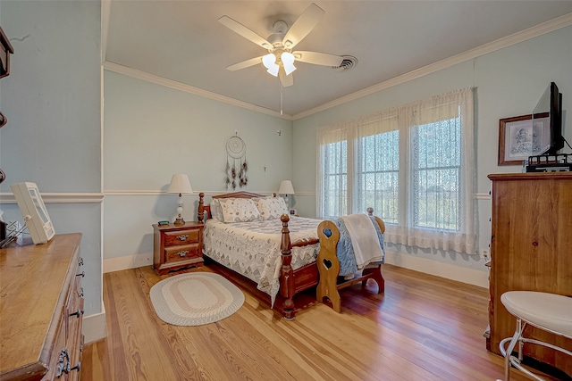 bedroom with light hardwood / wood-style flooring, ceiling fan, and crown molding