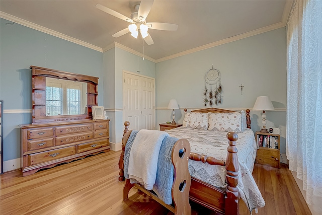 bedroom featuring crown molding, ceiling fan, a closet, and wood-type flooring