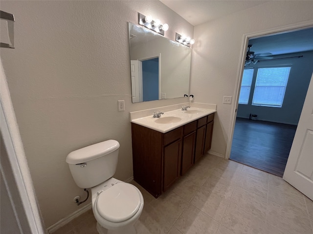 bathroom featuring hardwood / wood-style flooring, vanity, ceiling fan, and toilet