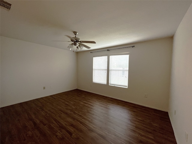 empty room with dark hardwood / wood-style flooring and ceiling fan