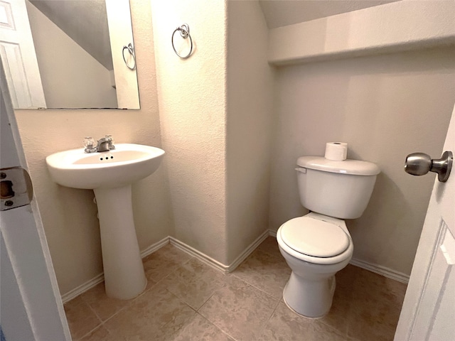 bathroom featuring tile patterned flooring and toilet