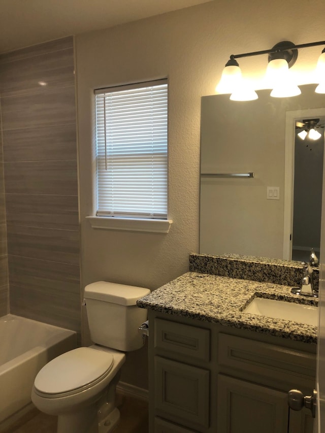 bathroom with vanity, ceiling fan, and toilet