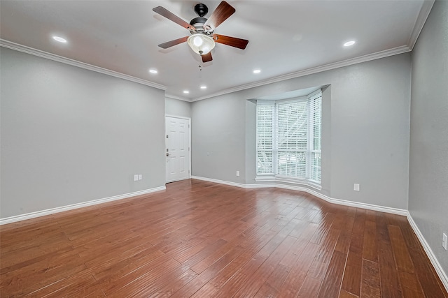 spare room featuring hardwood / wood-style flooring, ceiling fan, and crown molding