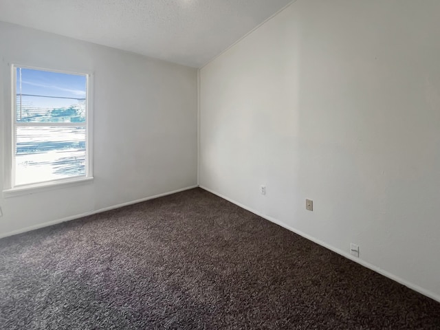 carpeted spare room featuring a textured ceiling