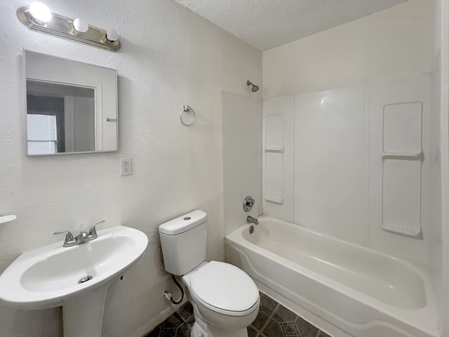 full bathroom featuring sink,  shower combination, toilet, and a textured ceiling