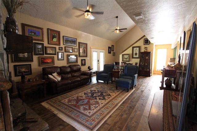 living room with hardwood / wood-style floors, ceiling fan, a textured ceiling, and vaulted ceiling