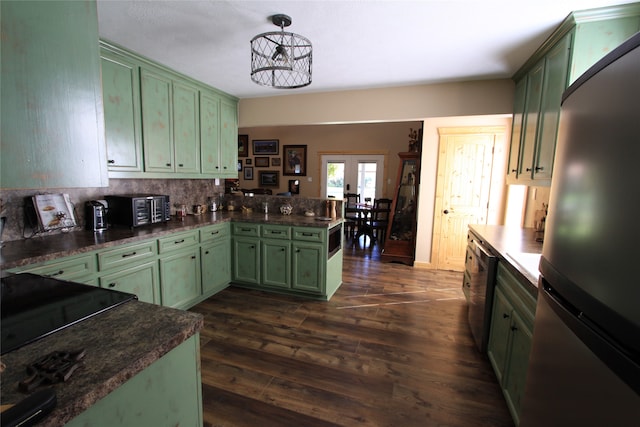 kitchen featuring hanging light fixtures, tasteful backsplash, dark hardwood / wood-style floors, appliances with stainless steel finishes, and green cabinetry