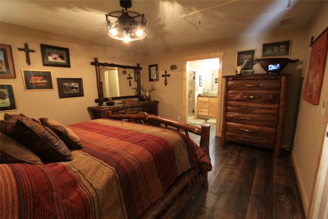 bedroom featuring connected bathroom and dark hardwood / wood-style flooring