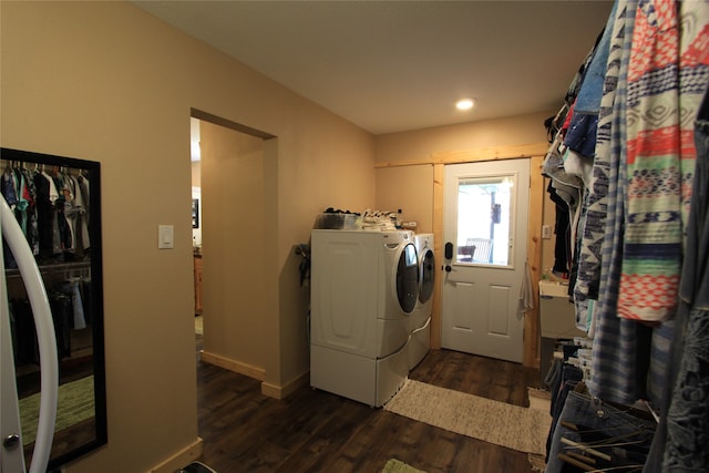 clothes washing area featuring dark hardwood / wood-style flooring and washer and dryer