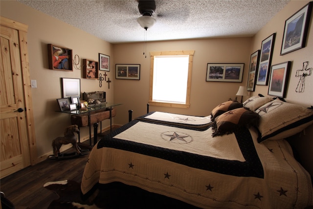 bedroom with a textured ceiling, ceiling fan, and dark hardwood / wood-style floors