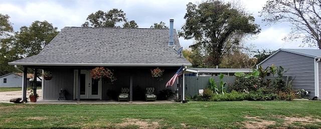 rear view of property with a lawn