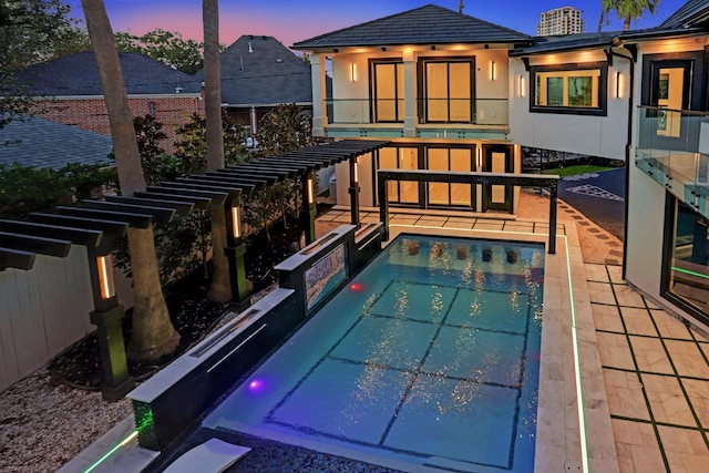 view of pool at dusk