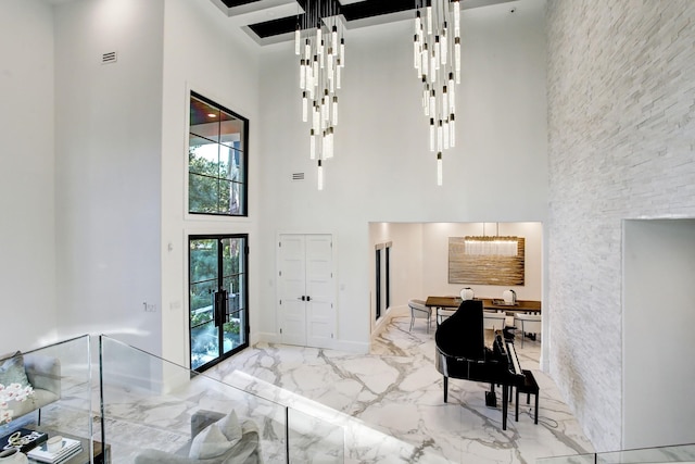 entrance foyer with a high ceiling and french doors