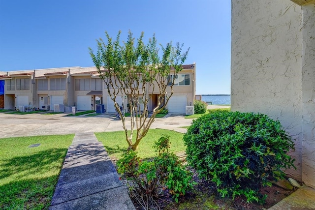 townhome / multi-family property featuring a garage and a water view