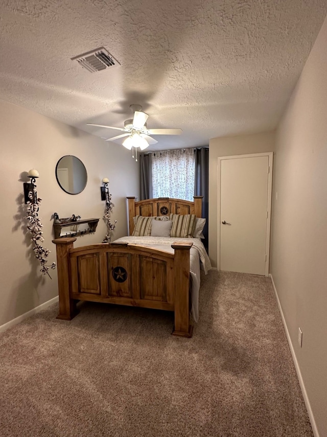 bedroom with a textured ceiling, carpet floors, and ceiling fan