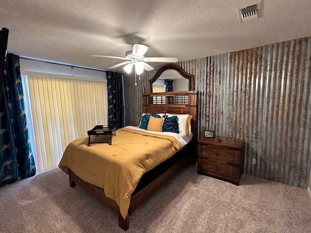 bedroom with carpet, ceiling fan, and a textured ceiling