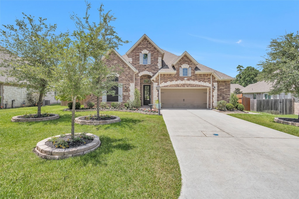 view of front of home with a front lawn and a garage