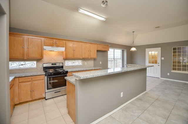 kitchen featuring a center island, stainless steel range with gas cooktop, and backsplash