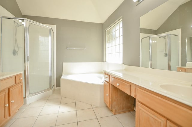 bathroom featuring tile patterned flooring, vanity, independent shower and bath, and vaulted ceiling