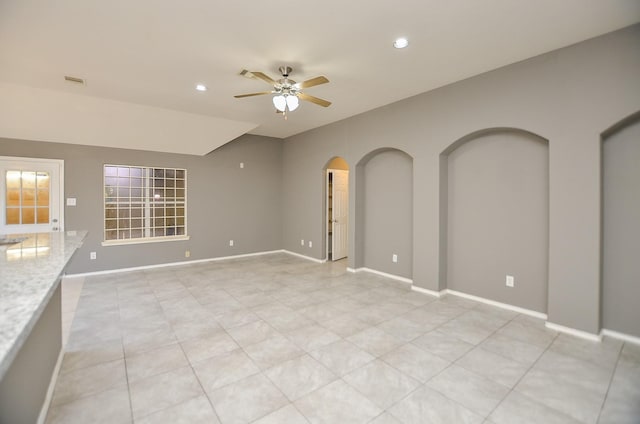 unfurnished living room featuring ceiling fan