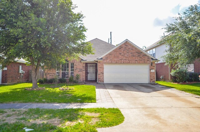 view of front of house featuring a front yard and a garage