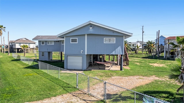 219 Fort Velasco Dr, Surfside Beach, TX 77541 - rear view of house with stairway, an attached garage, a gate, a carport, and driveway