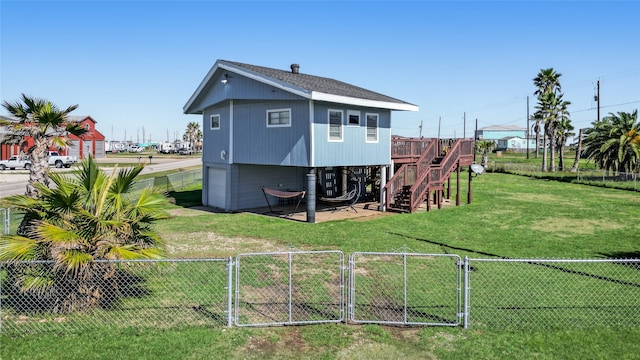 rear view of property with a lawn and a patio