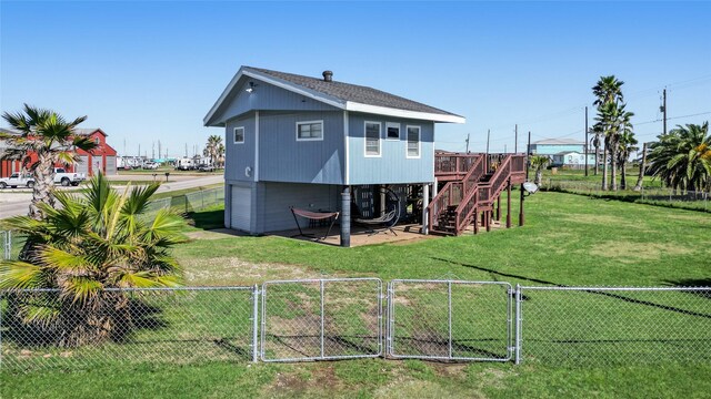 219 Fort Velasco Dr, Surfside Beach, TX 77541 - back of house with a gate, stairway, and a wooden deck