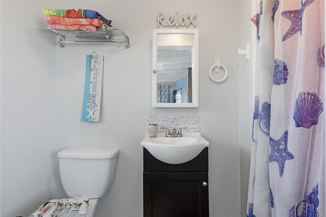 219 Fort Velasco Dr, Surfside Beach, TX 77541 - full bathroom with vanity, toilet, and a shower with curtain