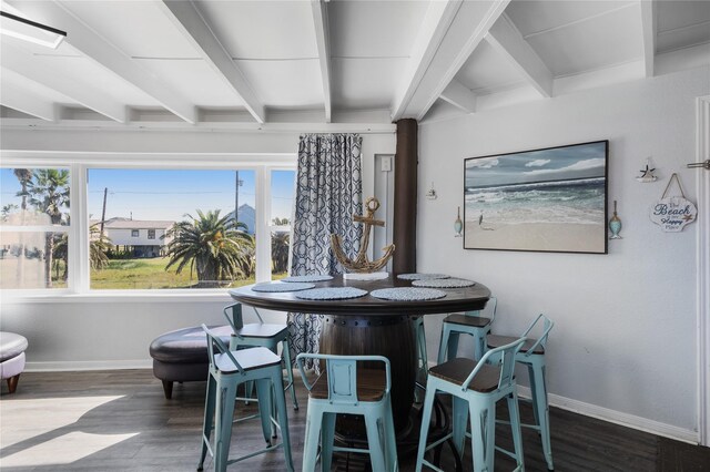 219 Fort Velasco Dr, Surfside Beach, TX 77541 - dining space featuring beam ceiling, baseboards, wood finished floors, and healthy amount of natural light