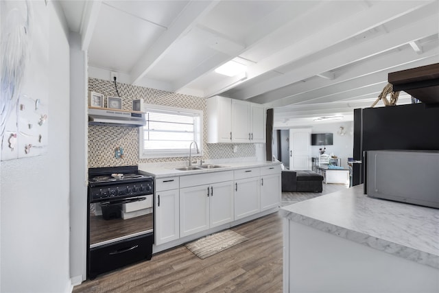 kitchen featuring white cabinets, ventilation hood, sink, decorative backsplash, and black range with gas cooktop