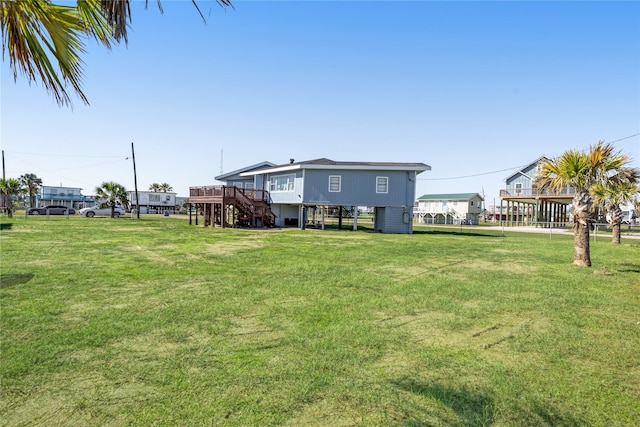 219 Fort Velasco Dr, Surfside Beach, TX 77541 - view of green lawn featuring stairway and a wooden deck