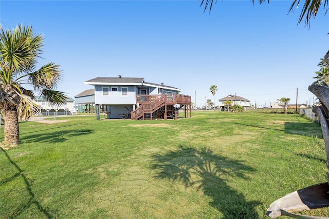 219 Fort Velasco Dr, Surfside Beach, TX 77541 - view of green lawn with stairs and a wooden deck