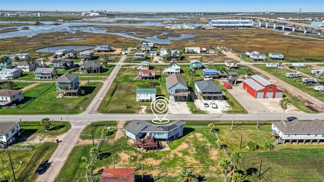 219 Fort Velasco Dr, Surfside Beach, TX 77541 - aerial perspective of suburban area with a large body of water and a notable bridge