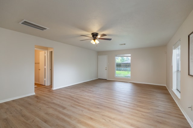 empty room with ceiling fan, a textured ceiling, and light hardwood / wood-style flooring