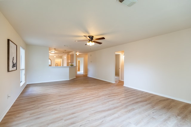 unfurnished living room with ceiling fan and light wood-type flooring