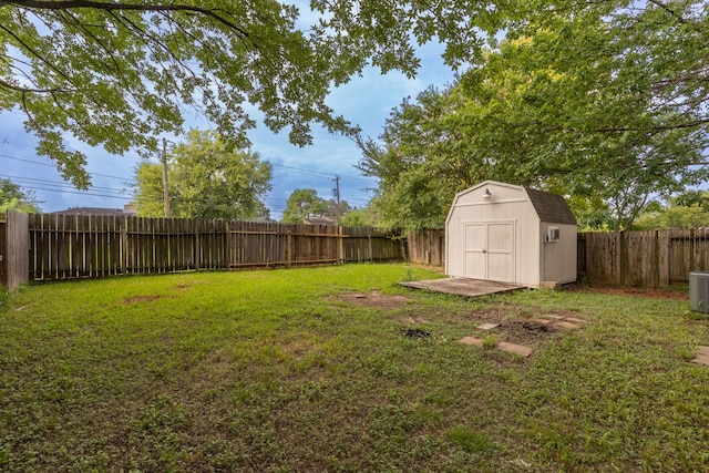 view of yard featuring a storage unit and central AC