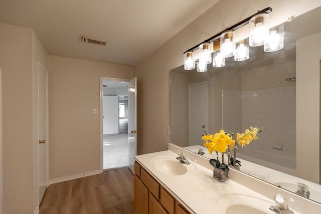 bathroom with hardwood / wood-style floors and vanity