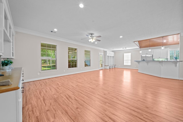 unfurnished living room with crown molding, ceiling fan, and light wood-type flooring