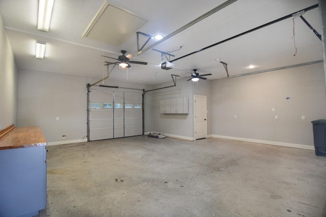 garage with ceiling fan and a garage door opener