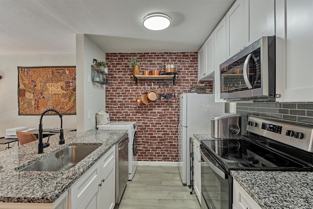 kitchen featuring white cabinets, sink, and stainless steel appliances