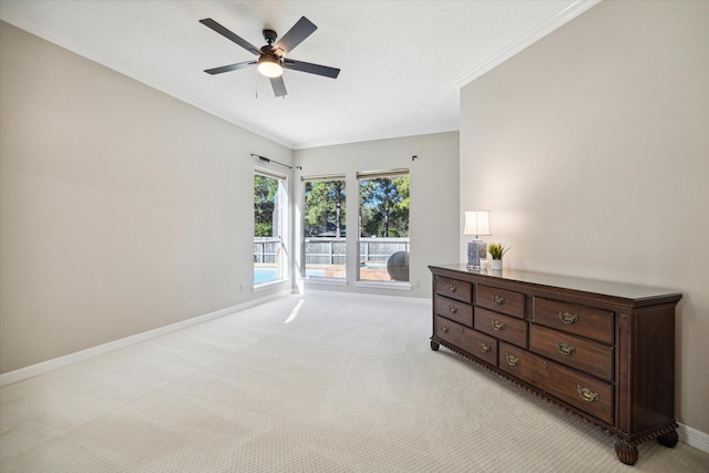 carpeted bedroom with ornamental molding and ceiling fan