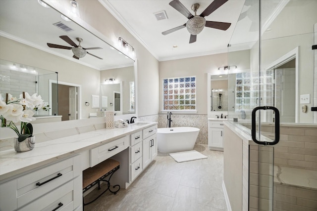 bathroom featuring crown molding, ceiling fan, tile walls, vanity, and plus walk in shower