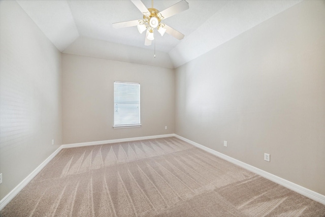 carpeted spare room featuring vaulted ceiling and ceiling fan