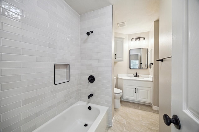 full bathroom featuring tile patterned flooring, vanity, toilet, and tiled shower / bath