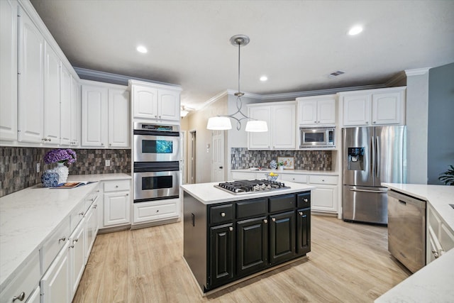 kitchen featuring white cabinetry, appliances with stainless steel finishes, and pendant lighting